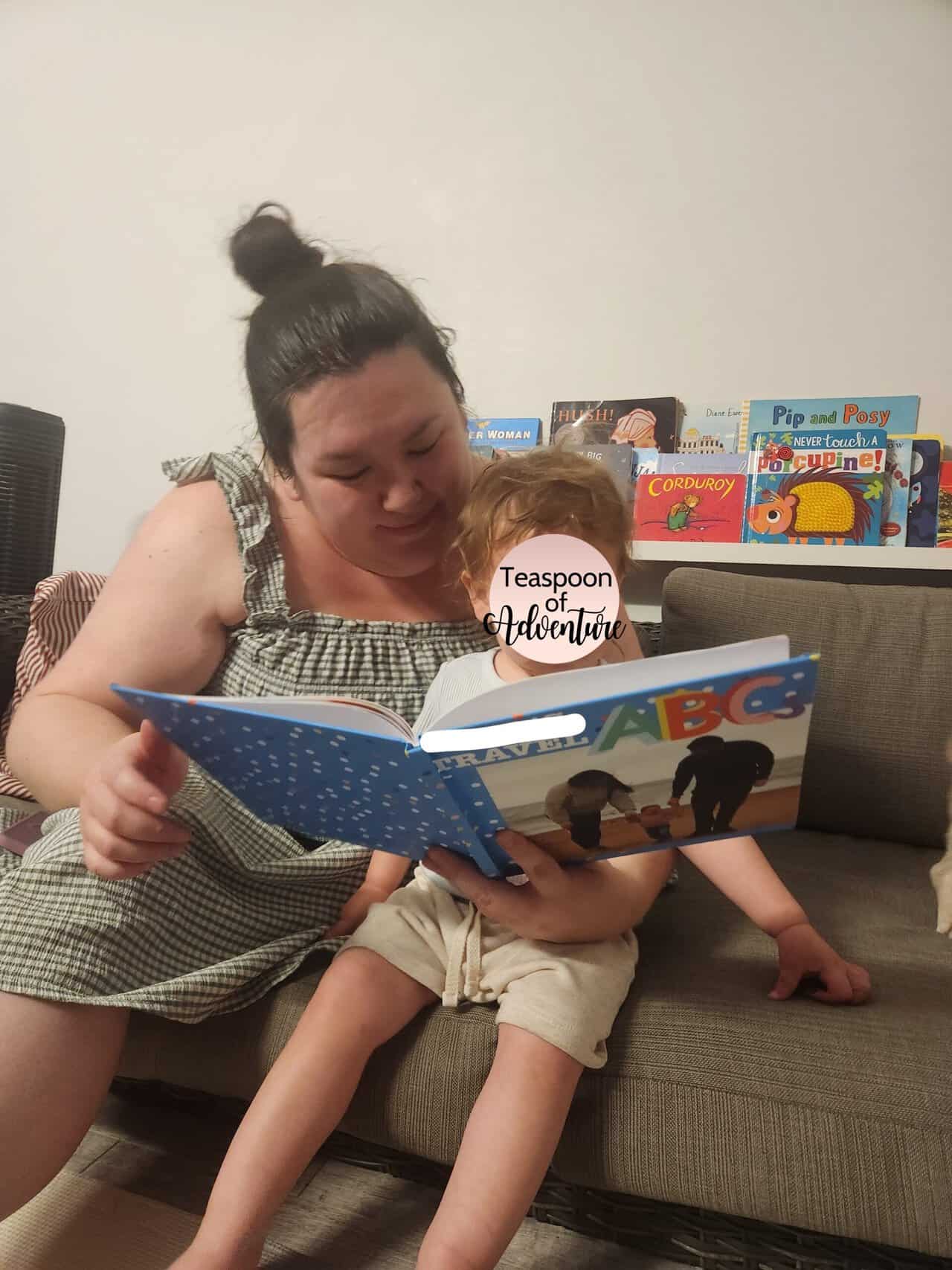 Making A Custom Board Book From Our Travel Photos 15 Riana and Baby C reading her custom board book, C's Travel ABCs, designed with Mixbook
