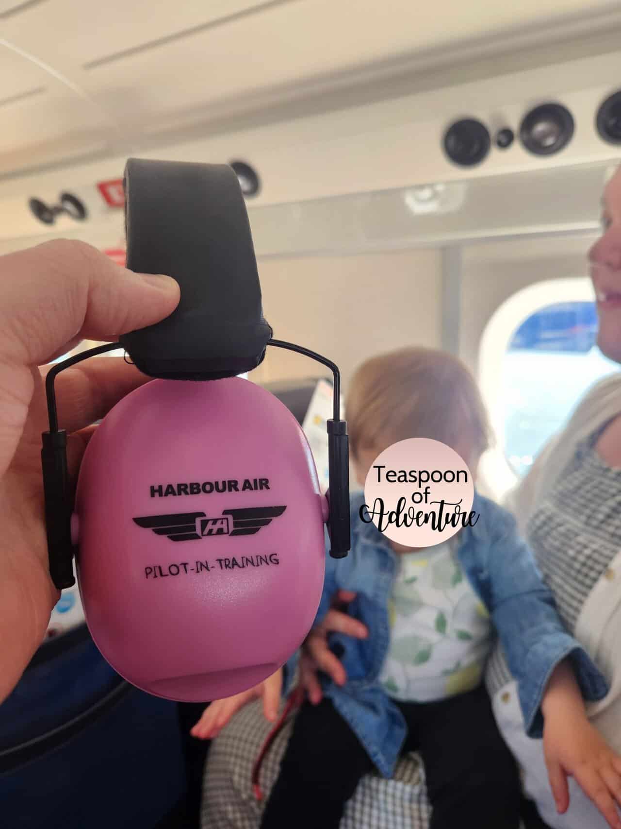 Should You Take a Seaplane to Victoria from Vancouver? (Harbour Air Review) 22 The pink ear protection Harbour Air provides for infants with Riana holding Baby C on her lap in the background