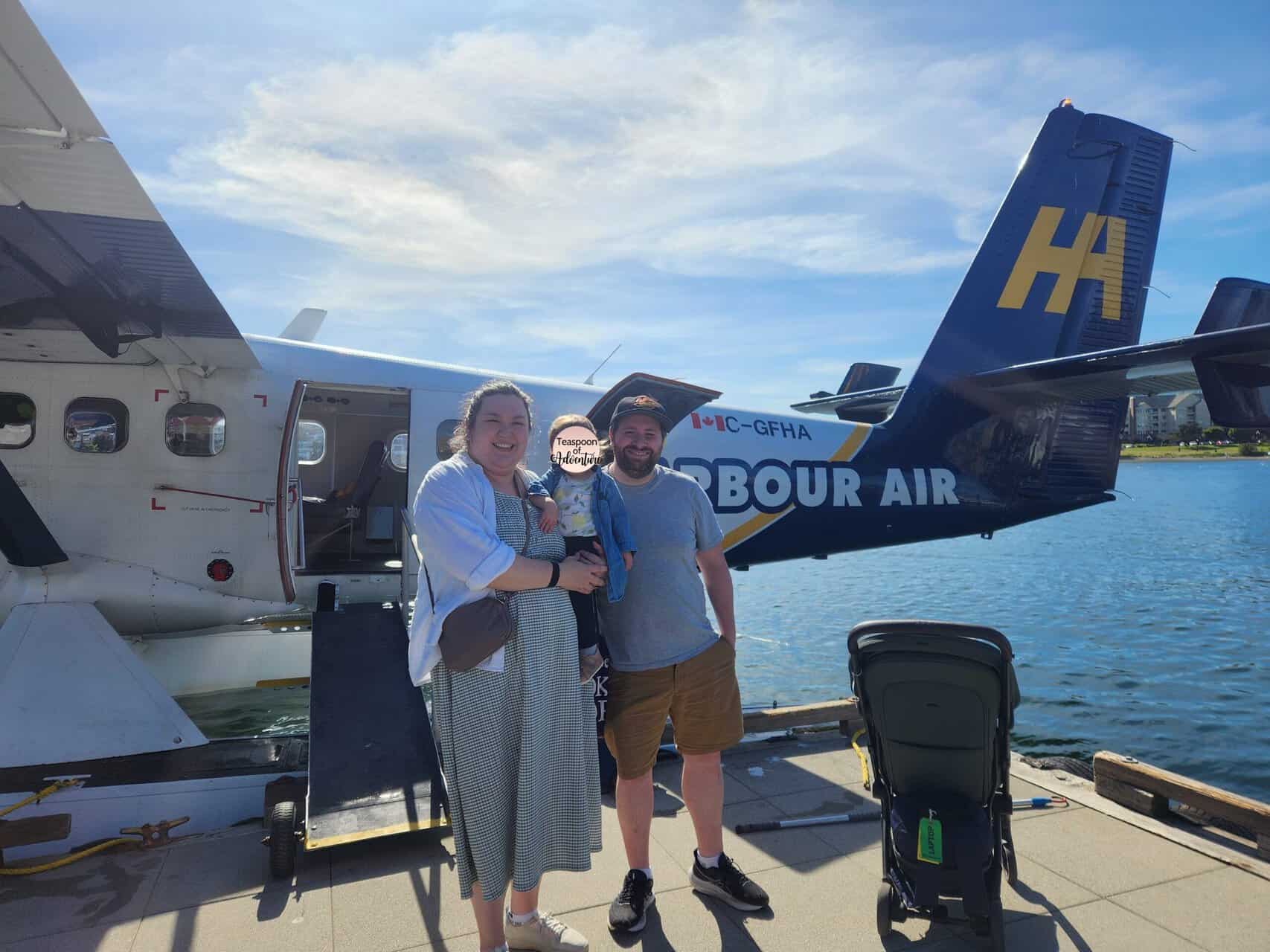 Should You Take a Seaplane to Victoria from Vancouver? (Harbour Air Review) 2 Riana, Colin and Baby C standing in front of a Harbour Air seaplane in Victoria Harbour