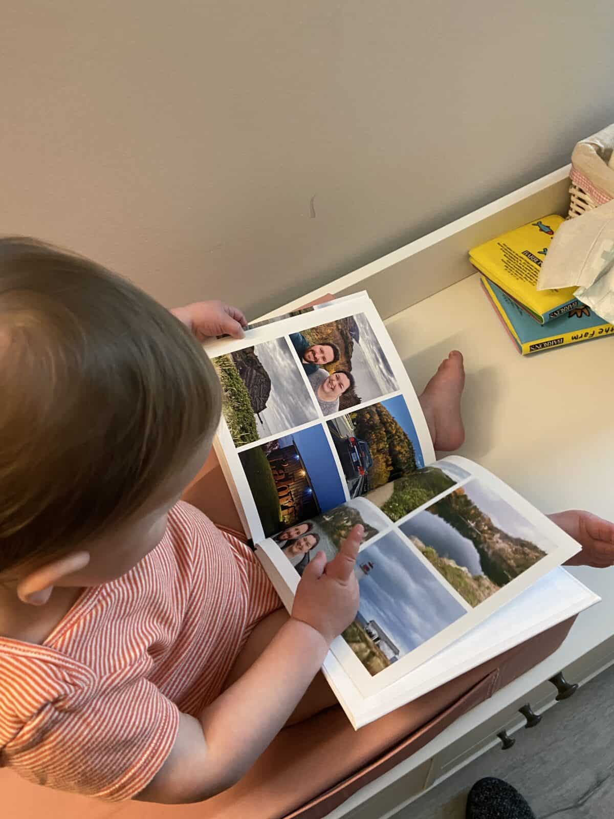 Making A Custom Board Book From Our Travel Photos 14 Baby C flipping through a custom photo book