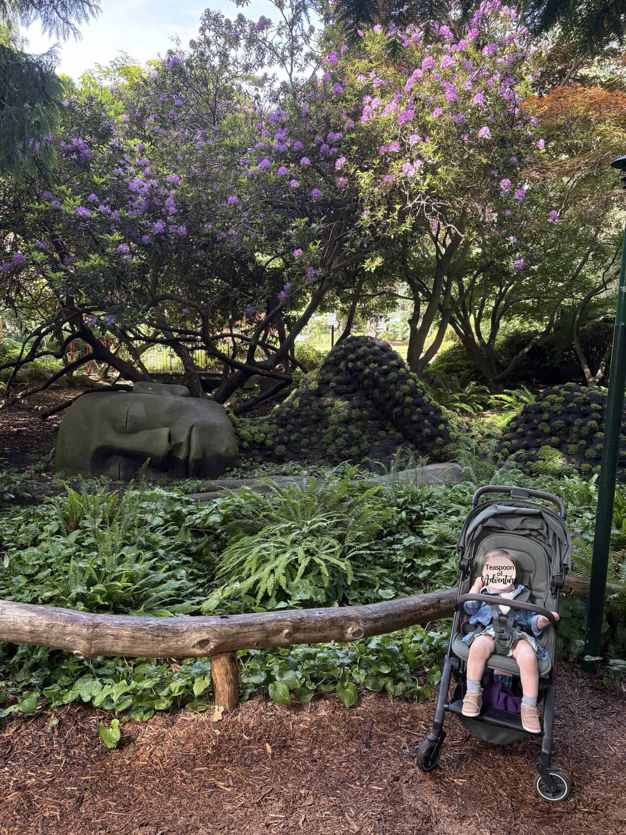 Baby C in her stroller in front of The Moss Lady at Beacon Hill Park, Victoria, BC