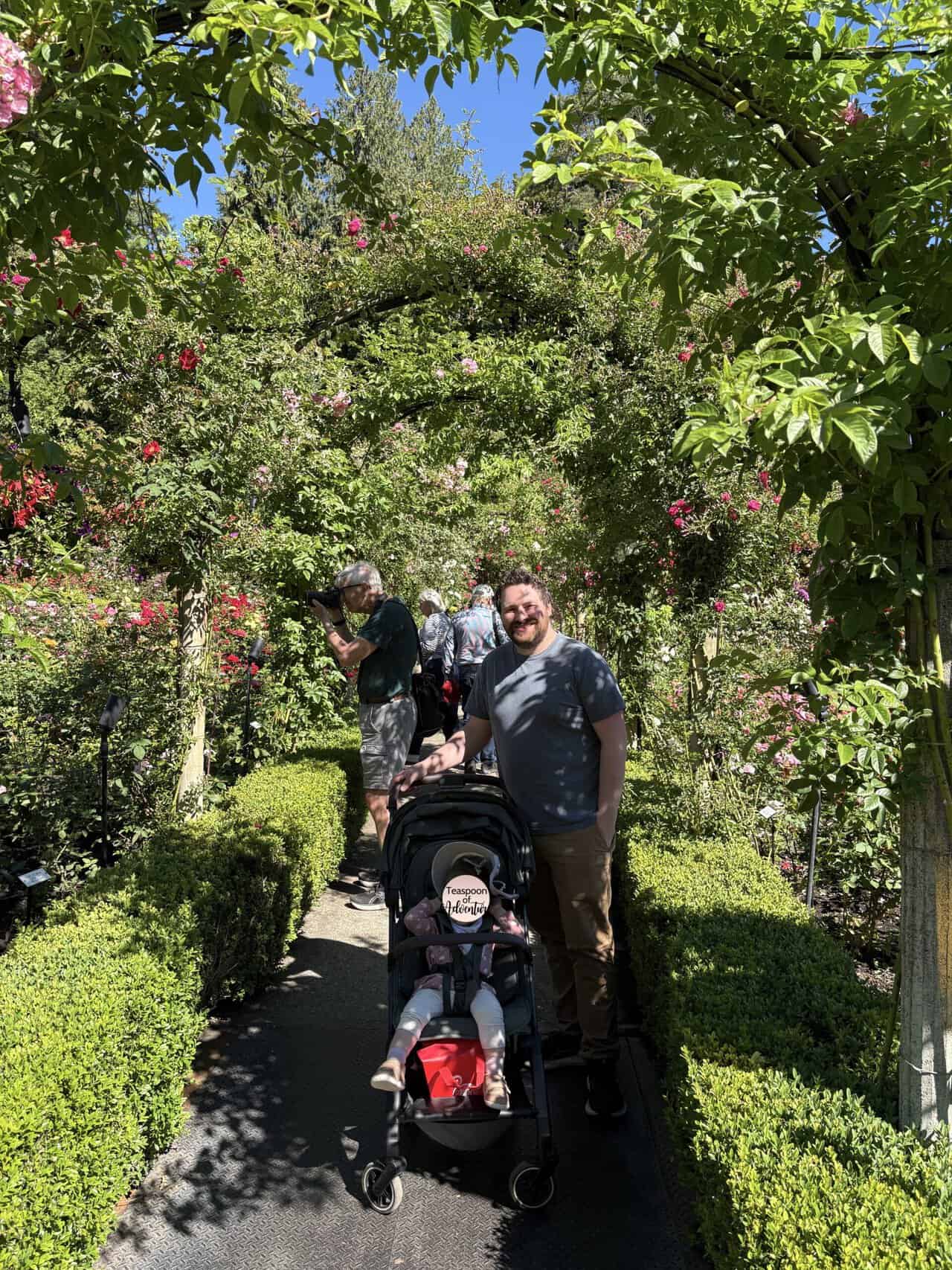Colin and Baby C smiling under arches in the Rose Garden at Butchart Gardens, Victoria
