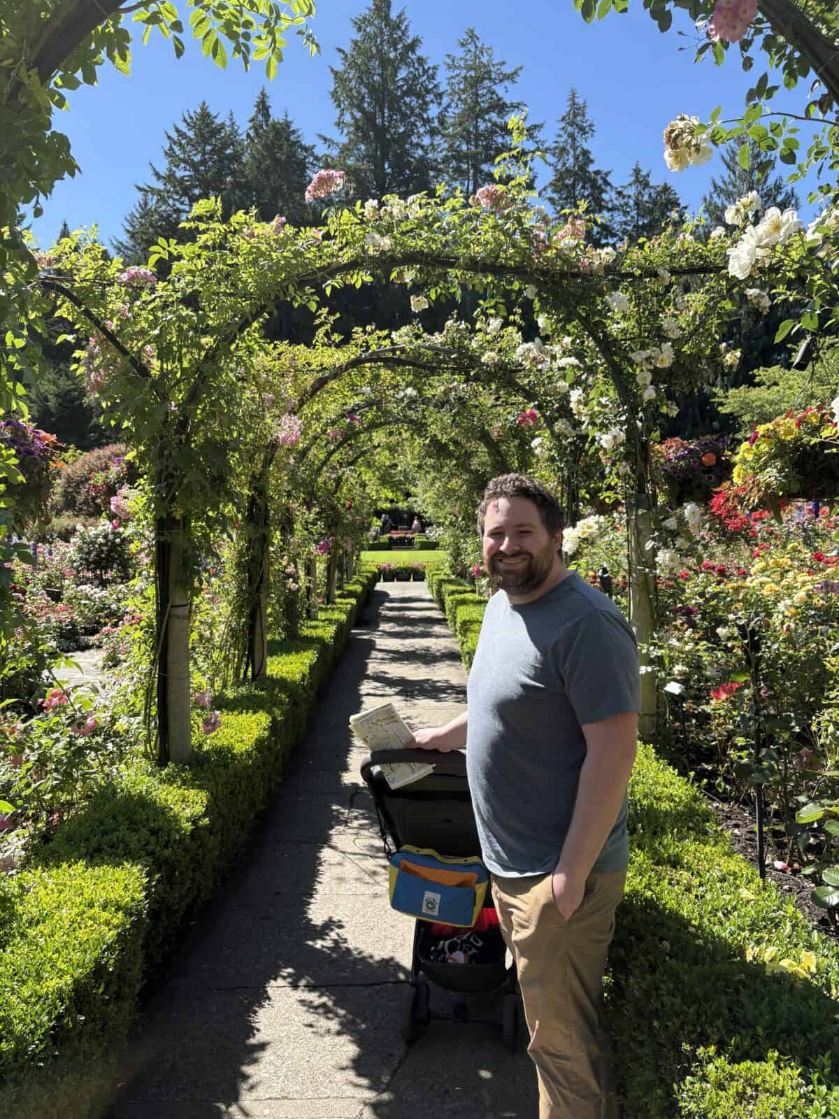 Colin smiling in the Rose Garden of Butchart Gardens
