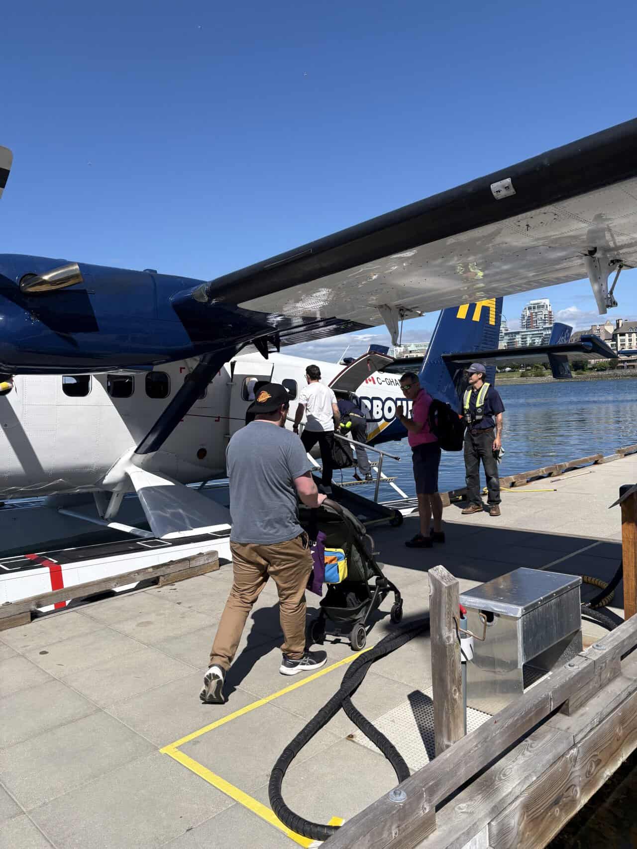Should You Take a Seaplane to Victoria from Vancouver? (Harbour Air Review) 21 Colin pushing Baby C's Joolz Aer travel stroller towards the seaplane doors at Victoria Harbour