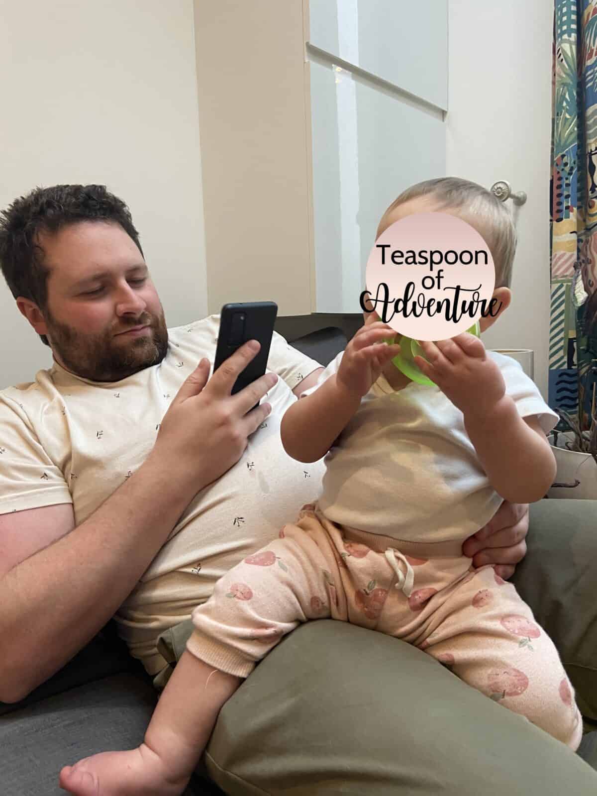 Why an eSIM Is Essential for Family Travel 6 Colin on his phone holding Baby C on his lap