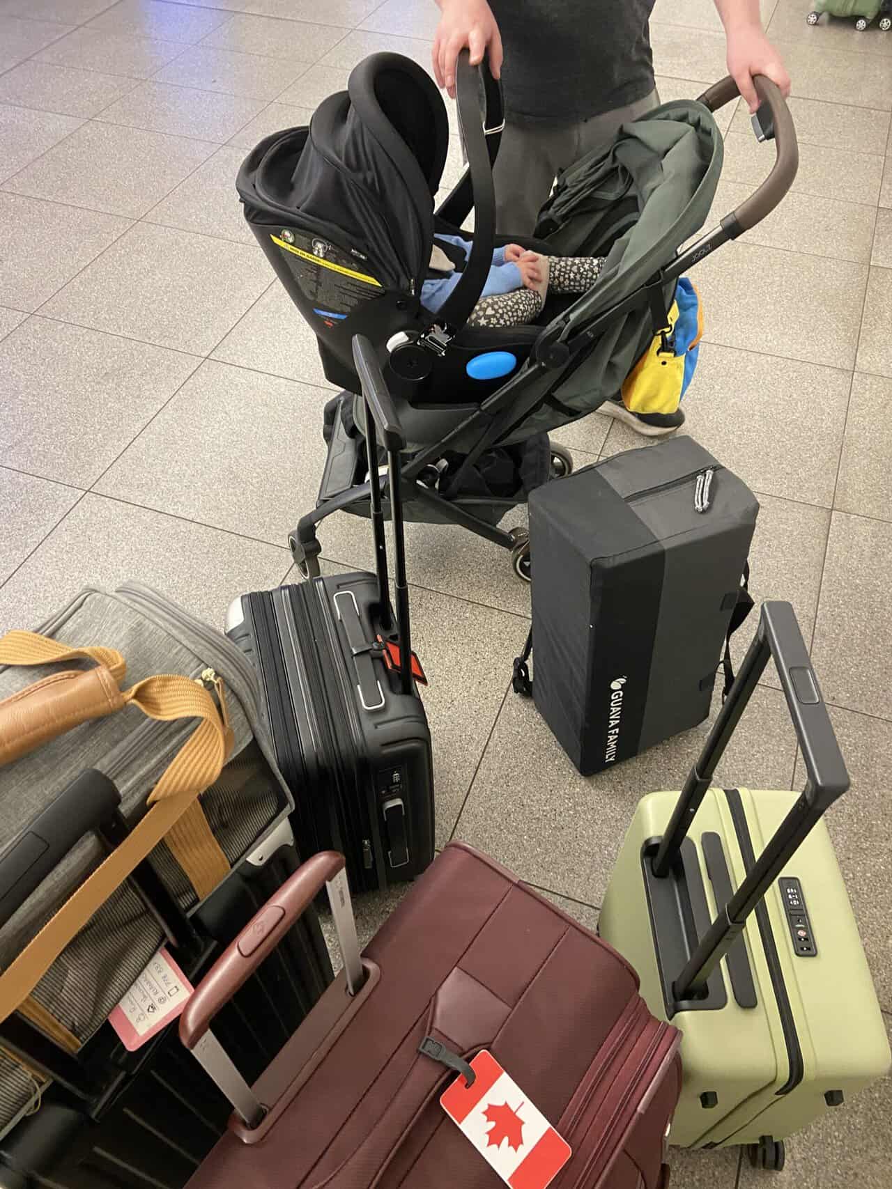 Tips for Flying With a Baby: From Booking to Baggage Claim 17 Suitcases, dog carrier, stroller and car seat on the platform of a London underground station