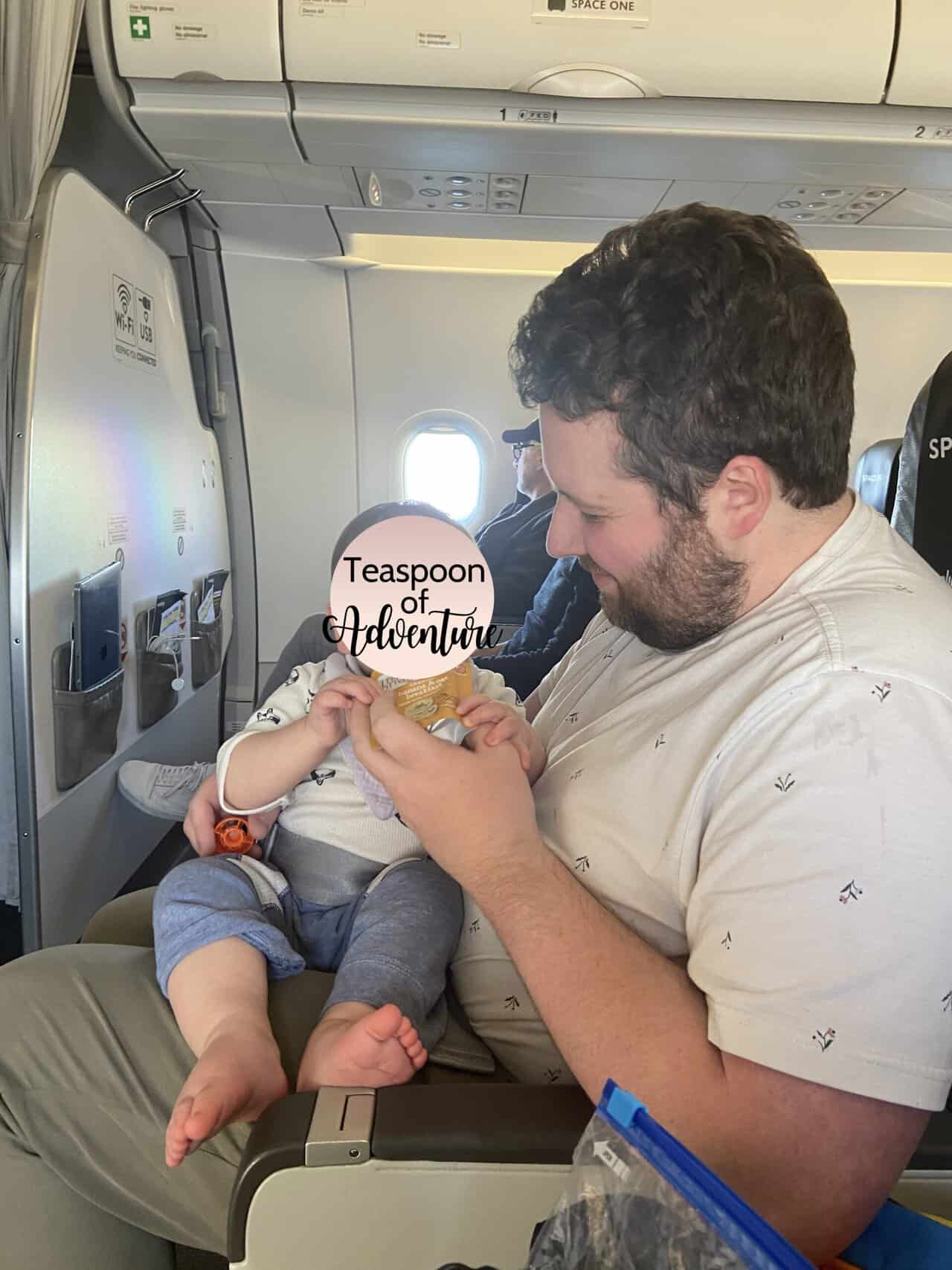Tips for Flying With a Baby: From Booking to Baggage Claim 6 Colin holding Baby C on his lap on our flight to Malaga from London