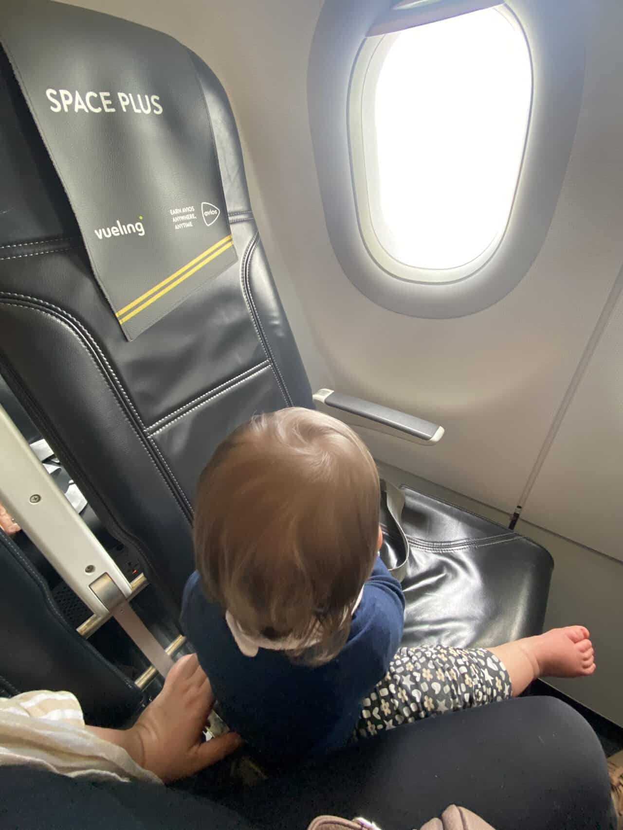 Tips for Flying With a Baby: From Booking to Baggage Claim 47 Baby C sitting on an airplane seat on our Vueling flight to Malaga