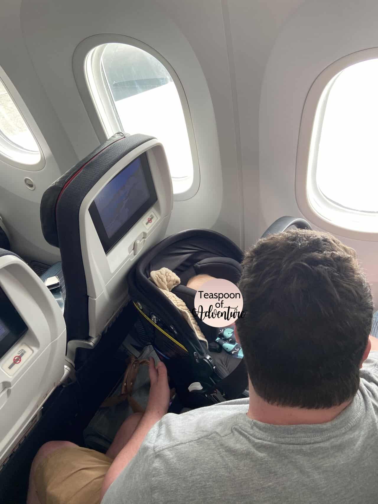 Tips for Flying With a Baby: From Booking to Baggage Claim 34 Colin getting Baby C and her car seat ready on the plane for flying with a baby