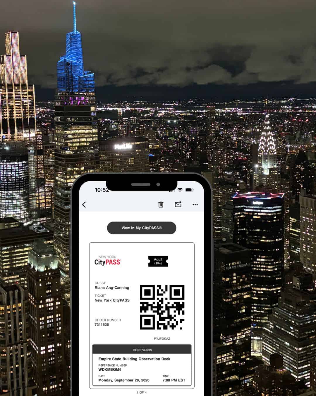 A phone screen showing CityPASS tickets for the Empire State Building in New York City with a view from the 86th floor in the background