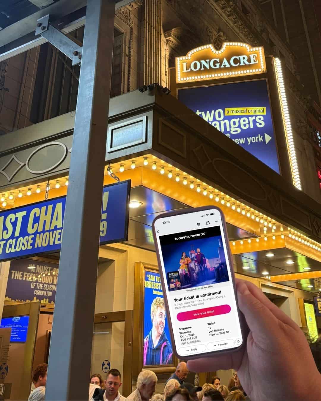 Riana's hand holding her phone showing Broadway tickets from TodayTix in front of Two Strangers Carry a Cake Across New York at Longacre Theatre in New York City